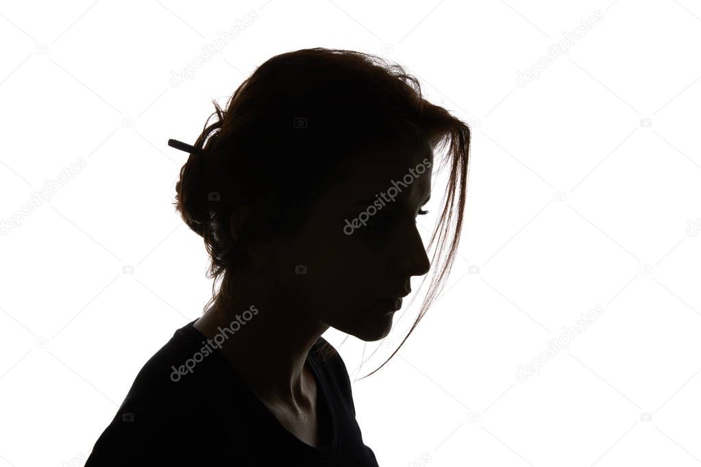 Silhouette of pensive woman looking down isolated on white
