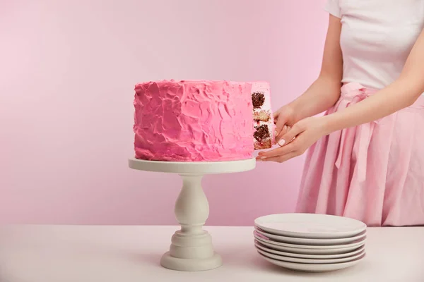 Vista Recortada Mujer Tomando Pedazo Pastel Cumpleaños Rosa Cerca Platillos —  Fotos de Stock