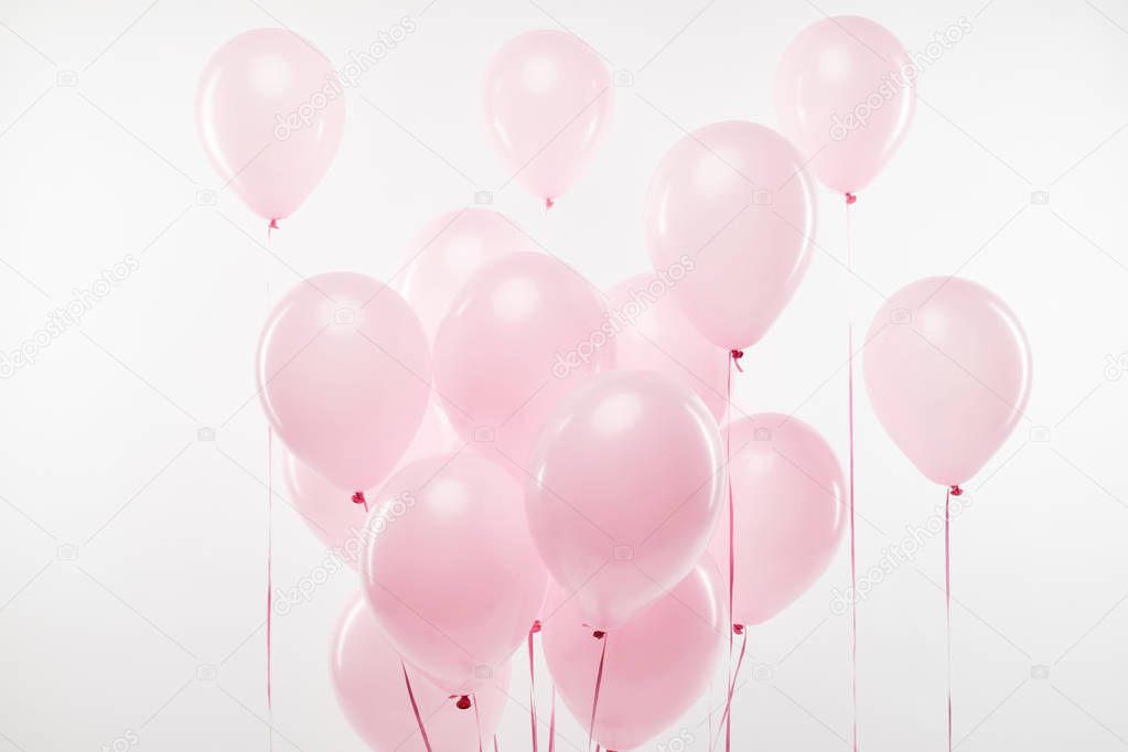 background with bundle of decorative pink air balloons on white