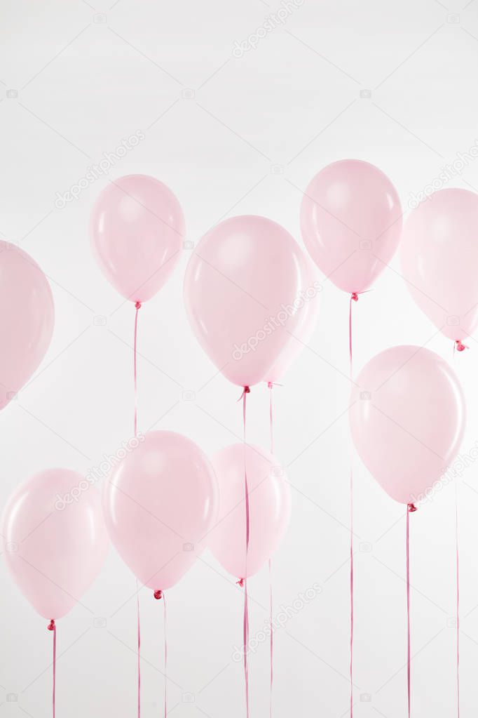 background with festive floating pink air balloons on white