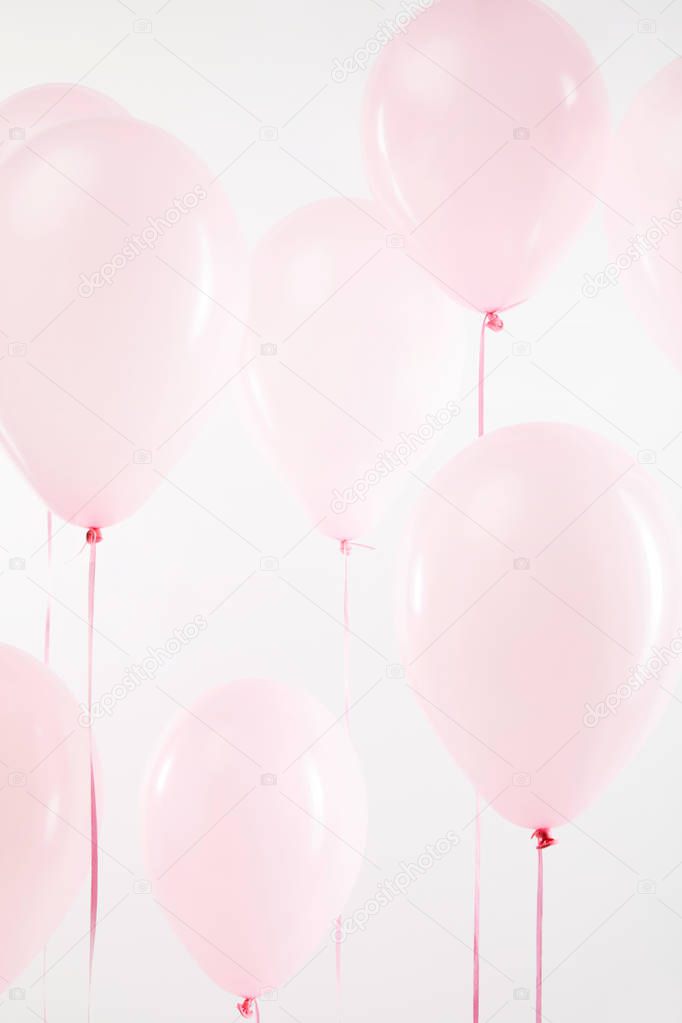 background with pink festive air balloons on white