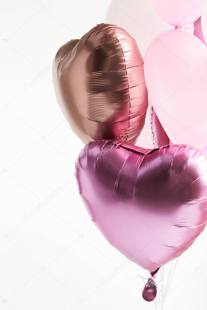 heart-shaped pink and golden festive air balloons isolated on white 