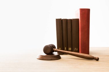wooden gavel and row of books on wooden table isolated on white clipart