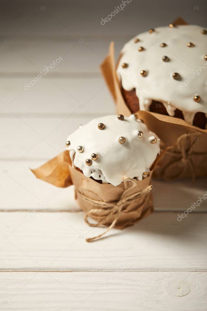 traditional delicious easter cakes on white wooden surface