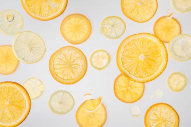 bright orange and lemon slices on grey background with water bubbles clipart