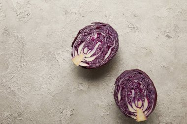 Top view of cut red cabbage on textured surface clipart