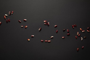 Top view of red beans on black surface clipart