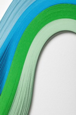 close up of wavy blue and green paper lines on grey background clipart