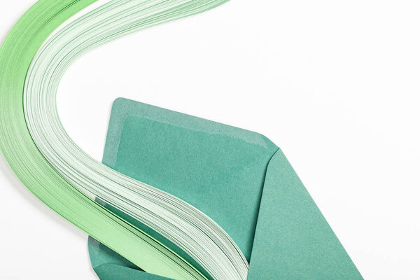 close up of green envelope with multicolored rainbow on white background