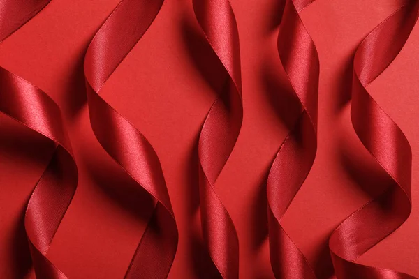 Close Wavy Silk Red Ribbons Red Background — Stock Photo, Image