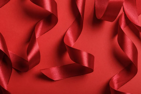 Close Curved Satin Red Ribbons Red Background — Stock Photo, Image