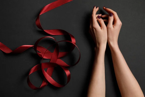 Cropped View Female Hands Satin Red Ribbon Black Background — Stock Photo, Image