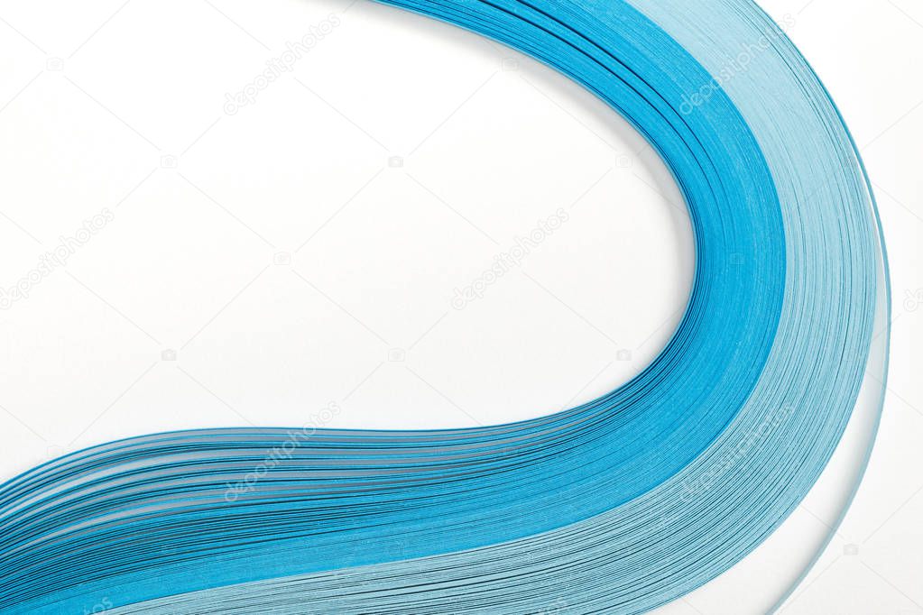 close up of wavy blue abstract paper lines on white background