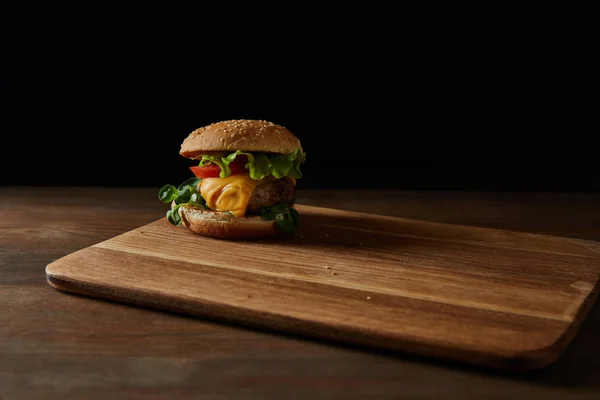 Tasty Meat Burger Sesame Wooden Chopping Board Isolated Black — Stock Photo, Image