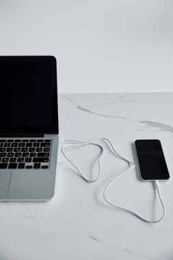 akıllı telefon, gri renkte izole edilmiş boş ekran ile Laptop kablosuyla bağlı