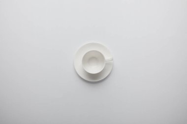 Top view of empty cup and saucer on grey clipart
