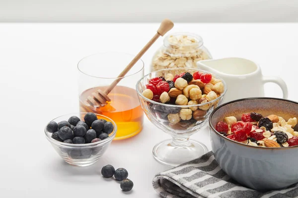 Muesli Berries Nuts Honey Bowls Served Nutritious Breakfast White Table — Stock Photo, Image