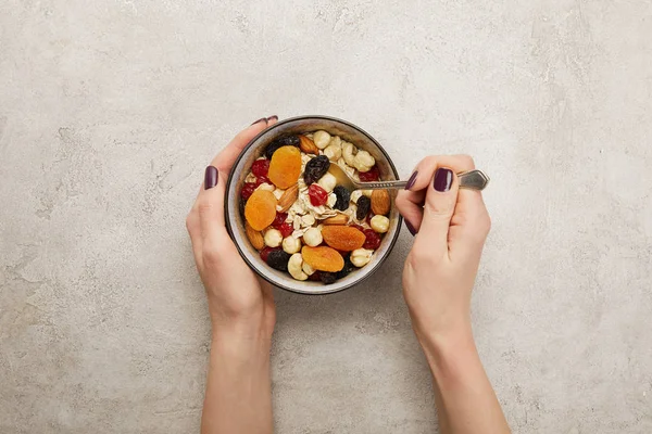 Cropped View Woman Holding Spoon Bowl Muesli Dried Apricots Berries — Stock Photo, Image