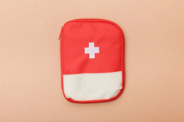 Top View Red First Aid Kit Bag Brown Surface — Stock Photo, Image