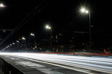 long exposure of lights on road at nighttime near buildings clipart