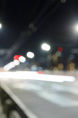 long exposure of bright lights on road at nighttime in city clipart