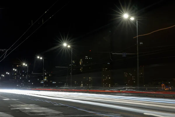 在建筑物附近的道路上长时间暴露灯光 — 图库照片