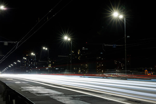 long exposure of lights on road at nighttime near buildings