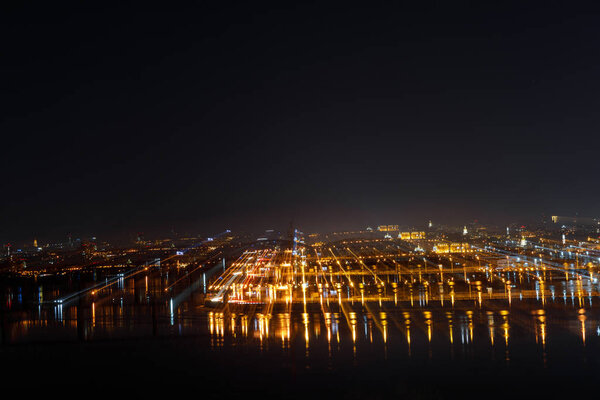 aerial view of tranquil cityscape with illuminated buildings at night