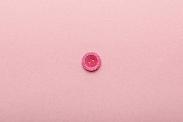 верхний вид кнопки одежды изолированы на розовый с копировальным пространством
