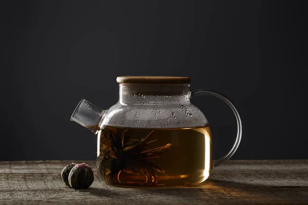 Transparent Teapot Blooming Tea Tea Balls Wooden Table Isolated Black — Stock Photo, Image