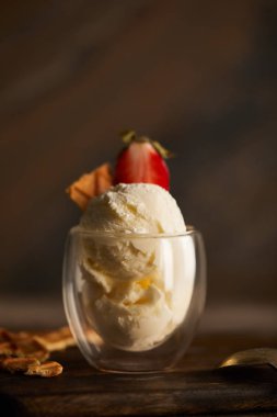 selective focus of delicious ice cream with piece of waffle and strawberry in glass  clipart