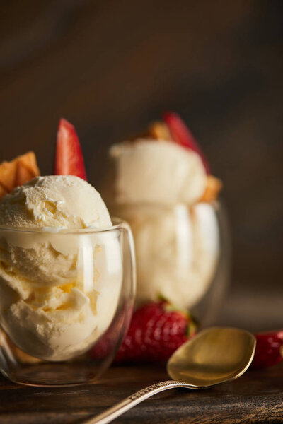 close up of delicious ice cream with strawberry in glass and spoon