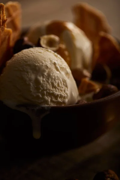 selective focus of delicious melting ice cream in bowl