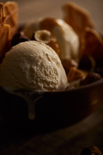 selective focus of delicious melting ice cream in bowl 