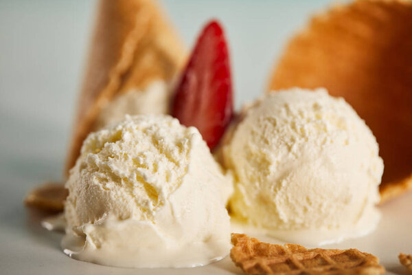close up view of delicious scoops of melting ice cream with strawberry