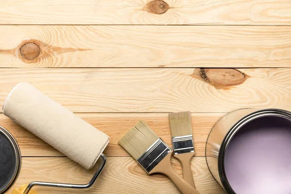 Top View Brushes Tin Purple Paint Paint Roller Wooden Surface — Stock Photo, Image