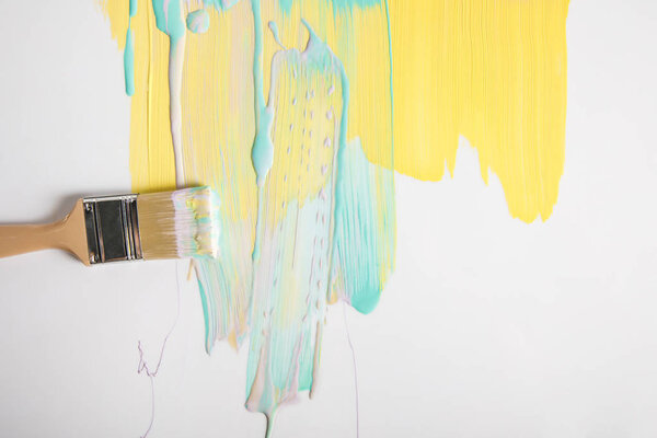 вид сверху кисти и красочные мазки кисти на белой поверхности
