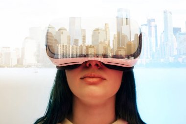 double exposure of brunette girl wearing virtual reality headset and modern city with skyscrapers  clipart