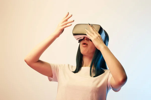 Surprised Young Woman Wearing Virtual Reality Headset Gesturing Beige Blue — Stock Photo, Image