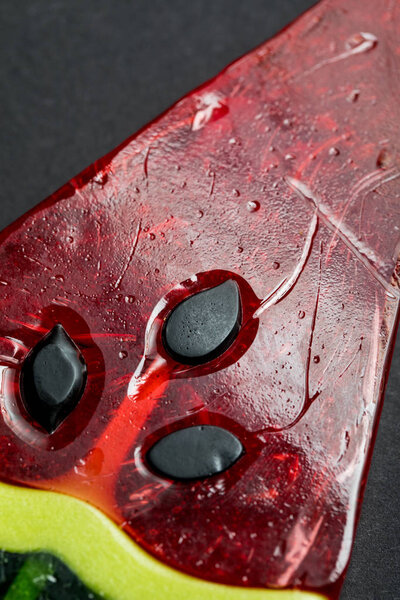 close up view of delicious shiny sweet lollipop in shape of watermelon