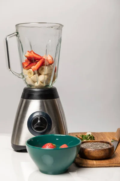 Sweet Strawberries Ripe Bananas Blender Bowls Cutting Board Grey — Stock Photo, Image