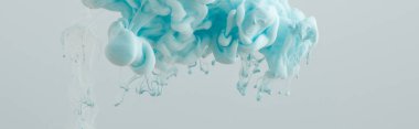 Close up view of light blue paint swirls isolated on grey clipart