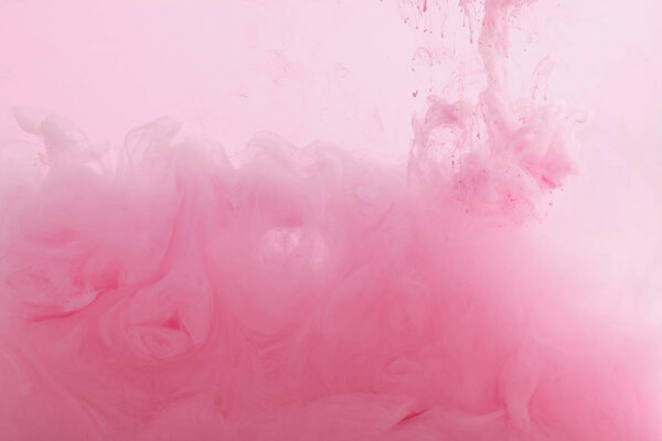 Close up view of pink paint mixing in water  