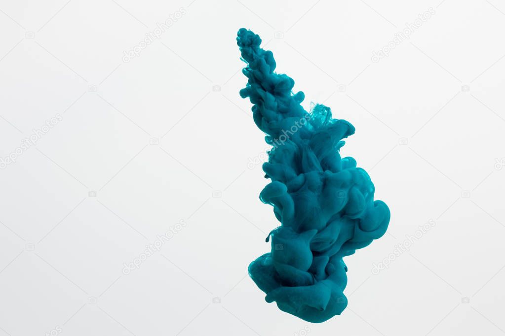 Close up view of dark blue paint swirl in water isolated on white