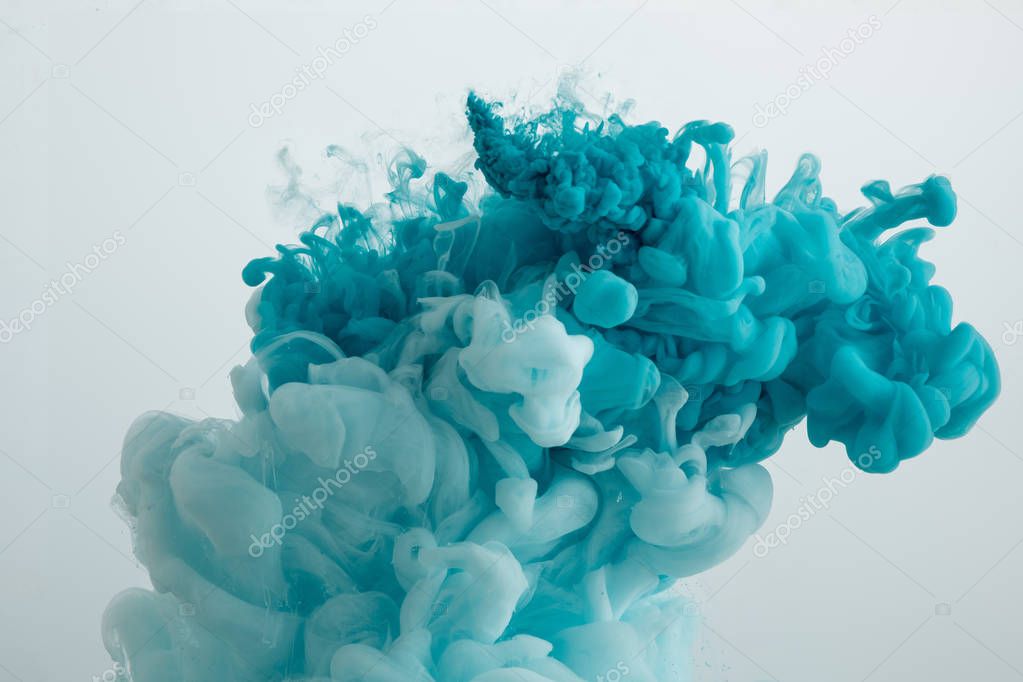 Close up view of turquoise paint swirls isolated on grey