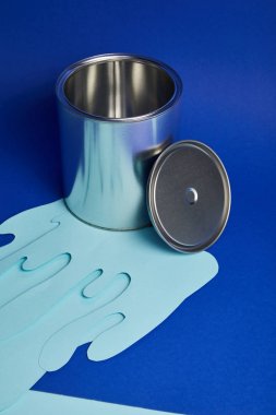 silver shiny can and dripping paper cut paint on bright blue background clipart