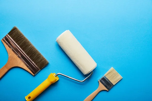 Top View Roller Brushes Blue Background Copy Space — Stock Photo, Image