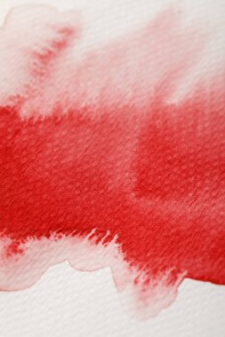 close up view of red watercolor paint wet spill on textured background  clipart