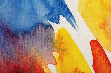 close up view of yellow, blue and red watercolor paint brushstrokes on white background clipart