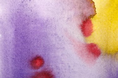 close up view of yellow, purple and red watercolor paint spills  clipart